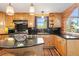 Bright kitchen featuring stainless steel appliances, granite countertops, and ample cabinet space at 6150 Bluebell Ln, Evergreen, CO 80439