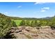 Expansive landscape featuring scenic mountain views and a verdant field, creating a serene environment at 6150 Bluebell Ln, Evergreen, CO 80439