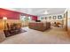 Large living room with comfortable seating, wood paneling, and ample natural light at 6150 Bluebell Ln, Evergreen, CO 80439