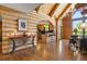 Log home showing entryway, and into kitchen with wood floors, log walls and archways at 6150 Bluebell Ln, Evergreen, CO 80439