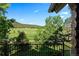 Expansive view of open fields and distant mountains from the deck at 6150 Bluebell Ln, Evergreen, CO 80439