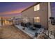 Backyard featuring a hot tub, fire pit, and patio with a view of sunset at 1788 Taos St, Brighton, CO 80603