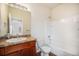Bright bathroom features a combination tub and shower, vanity, and tile floors at 1788 Taos St, Brighton, CO 80603