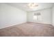 This bedroom features a neutral carpet, ceiling fan, and window at 1788 Taos St, Brighton, CO 80603