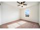 A bright bedroom with a ceiling fan and natural light through a window, complemented by plush carpet flooring at 1788 Taos St, Brighton, CO 80603