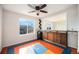 A bonus room featuring a mini fridge and wooden cabinets next to a large window that provides natural light at 1788 Taos St, Brighton, CO 80603