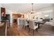 A dining room and kitchen featuring a large dining table, wood floors, and modern decor at 1788 Taos St, Brighton, CO 80603