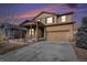 Two story home with welcoming porch, tan siding, two car garage and well manicured lawn at 1788 Taos St, Brighton, CO 80603