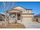 Charming two-story home with stone accents, neutral color palette, and an attached two-car garage on a beautiful sunny day at 1788 Taos St, Brighton, CO 80603