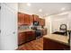 A modern kitchen featuring wood cabinets, dark appliances, and beautiful countertops at 1788 Taos St, Brighton, CO 80603