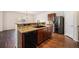 Kitchen with dark wood cabinets and a black sink at 1788 Taos St, Brighton, CO 80603