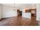 An open-concept living room and kitchen area with wood floors and modern decor at 1788 Taos St, Brighton, CO 80603