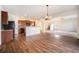 An open-concept living room and kitchen area with wood floors and modern decor at 1788 Taos St, Brighton, CO 80603