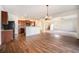 Spacious living room featuring hardwood flooring, a staircase, and an open view of the kitchen area at 1788 Taos St, Brighton, CO 80603