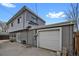 View of the back of the home and a one car detached garage with a large concrete patio at 1841 Ruth Dr, Thornton, CO 80229