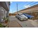 Backyard scene featuring classic cars, a privacy fence, and ample parking space at 1841 Ruth Dr, Thornton, CO 80229