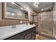 Bathroom featuring a double vanity, tile floors, and a glass enclosed shower at 1841 Ruth Dr, Thornton, CO 80229
