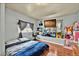 The bedroom is well-decorated, featuring an area for playing and a work space at 1841 Ruth Dr, Thornton, CO 80229