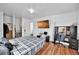 Comfortable bedroom featuring wood floors, a mounted TV, and a convenient desk area at 1841 Ruth Dr, Thornton, CO 80229