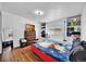 Cozy bedroom features wood-look flooring, shelving unit, and a large window for natural light at 1841 Ruth Dr, Thornton, CO 80229