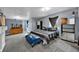 A spacious bedroom with carpet and a Broncos blanket on the bed at 1841 Ruth Dr, Thornton, CO 80229