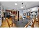 Open concept dining room with wood floors and view to the kitchen, living room and front door at 1841 Ruth Dr, Thornton, CO 80229