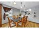 Inviting dining room with a modern light fixture and a view of the backyard at 1841 Ruth Dr, Thornton, CO 80229