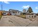 Home exterior displays a spacious driveway, gray siding, and an inviting front entrance at 1841 Ruth Dr, Thornton, CO 80229