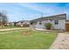 Cozy single-Gathering home featuring a green lawn and brick-lined garden at 1841 Ruth Dr, Thornton, CO 80229