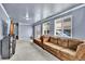 The living room features plush carpeting, a comfortable sofa, and abundant natural light at 1841 Ruth Dr, Thornton, CO 80229