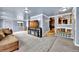 Spacious living room with plush gray carpet, TV, and easy access to the kitchen and outside at 1841 Ruth Dr, Thornton, CO 80229