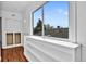 Bright sun room with shelving, a large window, and a view of the rooftop at 1841 Ruth Dr, Thornton, CO 80229