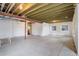 Spacious unfinished basement featuring exposed ceiling beams, concrete floor, and natural light at 2305 Prospect Ln, Broomfield, CO 80023