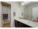 Bright bathroom featuring a double sink vanity with a marble countertop and a separate shower at 2305 Prospect Ln, Broomfield, CO 80023