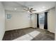 Spacious bedroom featuring plush carpet, ceiling fan, and natural light at 2305 Prospect Ln, Broomfield, CO 80023