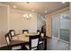 Bright dining room features a stylish chandelier and sliding glass doors to the outside at 2305 Prospect Ln, Broomfield, CO 80023
