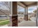 View from the front porch, showcasing stone-clad pillars and a glimpse of the neighborhood street at 2305 Prospect Ln, Broomfield, CO 80023