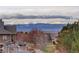 Scenic mountain views from the backyard deck of this home nestled among trees and open space at 2305 Prospect Ln, Broomfield, CO 80023