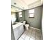 Bathroom featuring a sink, toilet, mirror and a window at 4243 Flanders St, Denver, CO 80249