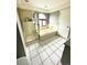 Bright bathroom featuring a bathtub, shower and white tile flooring at 4243 Flanders St, Denver, CO 80249