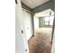 View into the bedroom showcasing carpet, a large window and an arched doorway at 4243 Flanders St, Denver, CO 80249