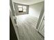 Bedroom with light wood floor, a window with wood frame and grey walls at 4243 Flanders St, Denver, CO 80249