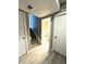 Hallway featuring light wood floors leading to bathroom at 4243 Flanders St, Denver, CO 80249