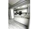 Modern kitchen features white cabinets, granite countertops, stainless steel appliances, and a breakfast bar at 4243 Flanders St, Denver, CO 80249