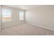 Bedroom featuring neutral carpet and two windows letting in natural light at 1850 Sawtooth Mountain Dr, Berthoud, CO 80513