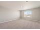 Bright bedroom with plush carpeting and ample natural light from a large window at 1850 Sawtooth Mountain Dr, Berthoud, CO 80513