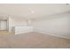 Neutral bonus room with carpet floors, white walls, and a half wall at 1850 Sawtooth Mountain Dr, Berthoud, CO 80513