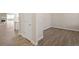 Hallway area showcasing modern flooring, trim, and a doorway leading to another room at 1850 Sawtooth Mountain Dr, Berthoud, CO 80513
