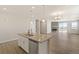 Open-concept kitchen with an island that flows into a bright living area with a fireplace at 1850 Sawtooth Mountain Dr, Berthoud, CO 80513