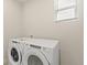 Laundry room with a side-by-side washer and dryer set, illuminated by natural light at 1850 Sawtooth Mountain Dr, Berthoud, CO 80513
